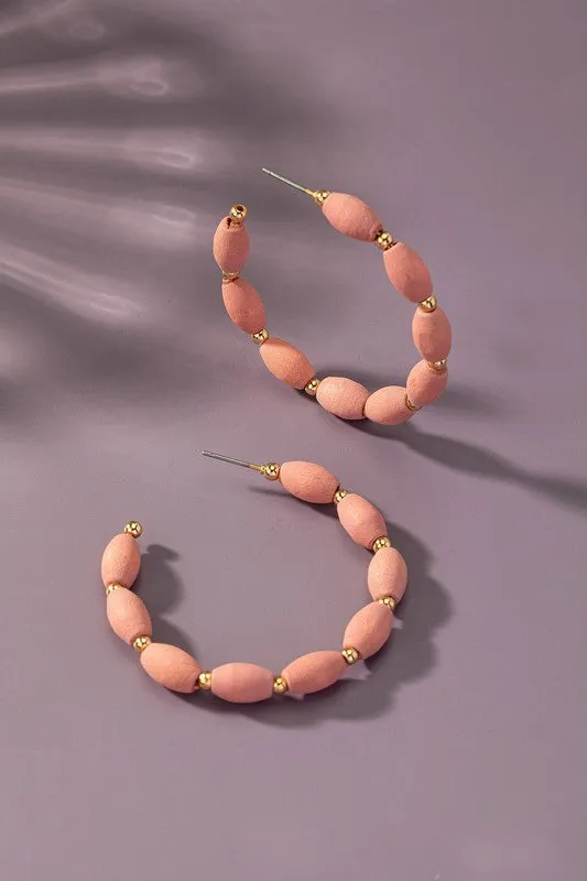 Spindle shape wood beaded hoop earrings