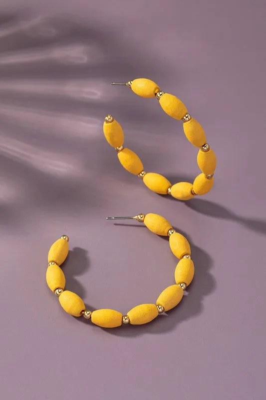 Spindle shape wood beaded hoop earrings
